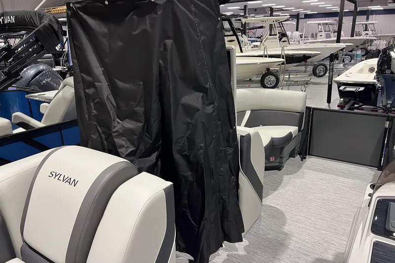 Slide: The Image of 2025 Sylvan Mirage X X3 CLZ pontoon boat interior with seating and privacy curtain. - 16