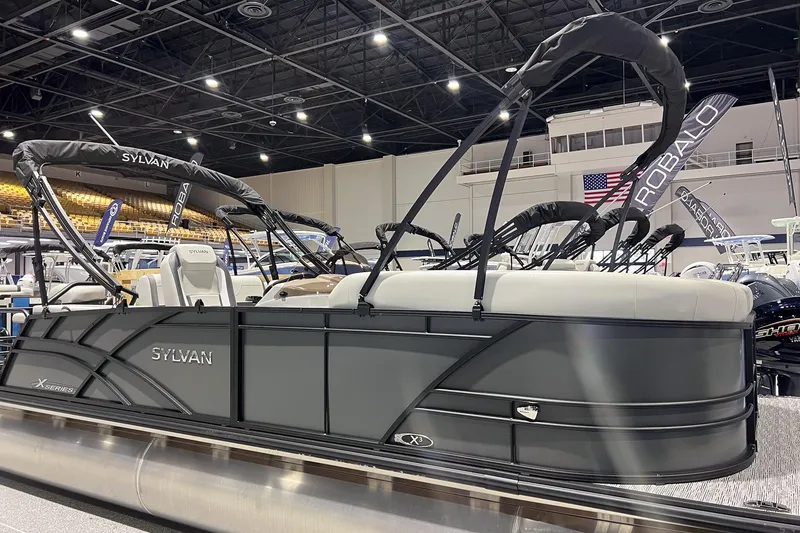 Slide: The Image of 2025 Sylvan Mirage X X3 CLZ pontoon boat displayed at indoor boat show. - 3