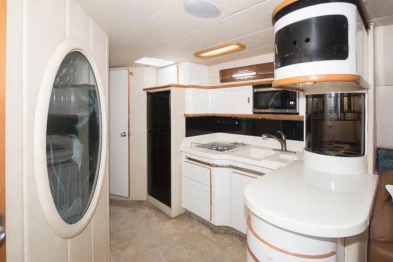 Slide: The Image of Interior of 1998 Sea Ray 500 Sundancer yacht with modern kitchen amenities. - 10