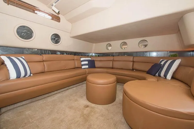 Slide: The Image of Luxurious interior of 1998 Sea Ray 500 Sundancer yacht with leather seating and portholes. - 11
