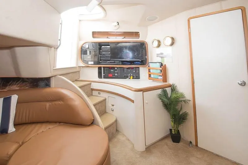 Slide: The Image of Interior of 1998 Sea Ray 500 Sundancer yacht with leather seating and control panel. - 12