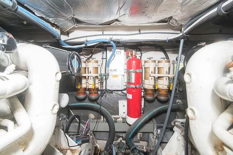 Slide: The Image of Engine room of a 1998 Sea Ray 500 Sundancer with fire extinguisher and fuel filters. - 15