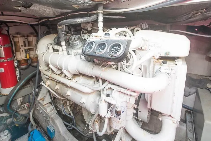 Slide: The Image of Engine room of a 1998 Sea Ray 500 Sundancer yacht, showcasing mechanical components. - 16