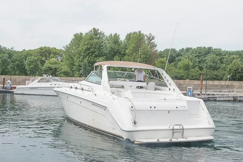 Slide: The Image of 1998 Sea Ray 500 Sundancer yacht docked in a serene marina setting. - 3