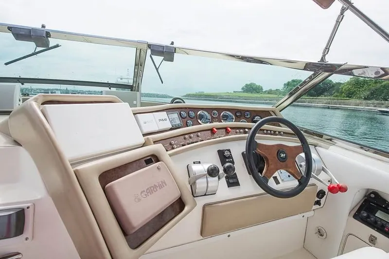 Slide: The Image of 1998 Sea Ray 500 Sundancer helm with steering wheel and control panel. - 7