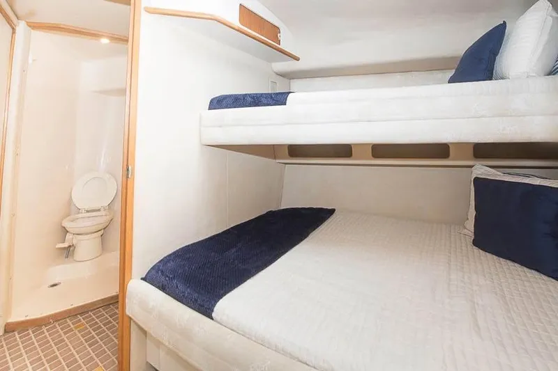 Slide: The Image of Interior of 1998 Sea Ray 500 Sundancer with bunk beds and bathroom. - 8