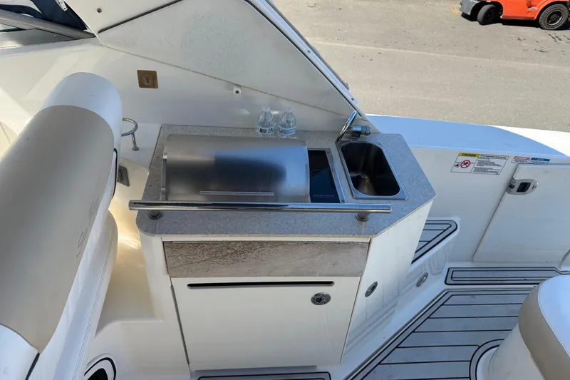 Slide: The Image of Cockpit view of 2010 Sea Ray 310 Sundancer with sink and grill station. - 10