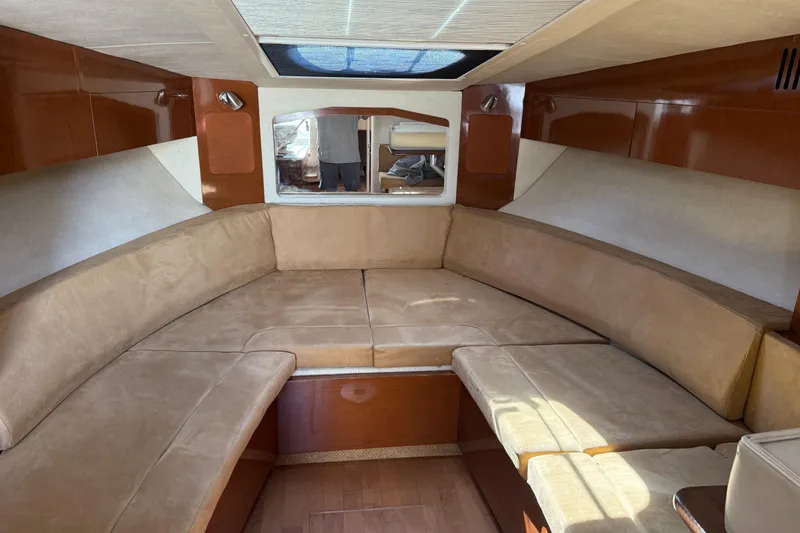 Slide: The Image of Interior of 2010 Sea Ray 310 Sundancer with beige seating and wood accents. - 11