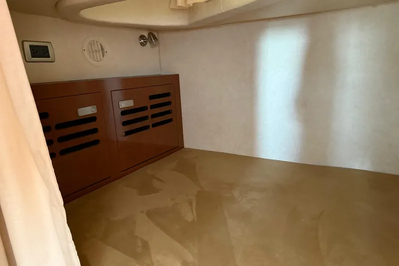 Slide: The Image of Interior cabin of 2010 Sea Ray 310 Sundancer with wooden storage cabinets. - 12