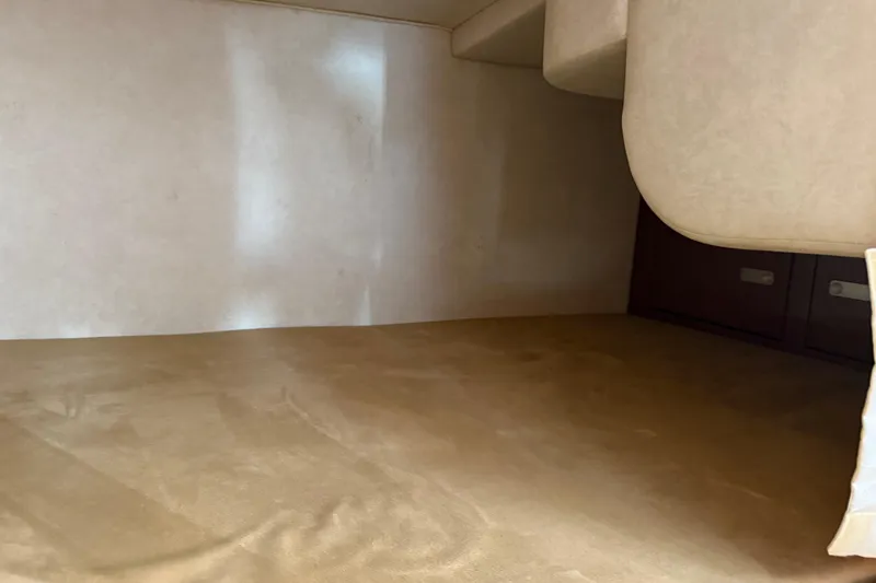 Slide: The Image of Interior cabin space of 2010 Sea Ray 310 Sundancer, featuring beige upholstery. - 13