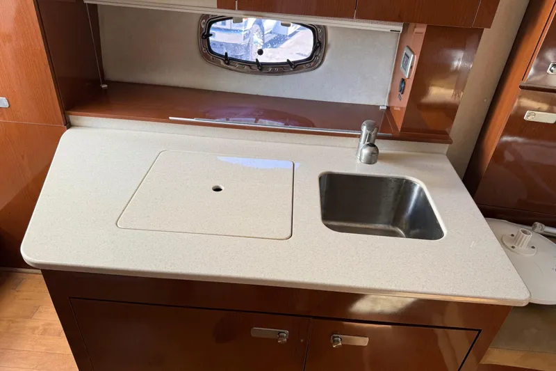 Slide: The Image of 2010 Sea Ray 310 Sundancer kitchen area with sink and countertop. - 14