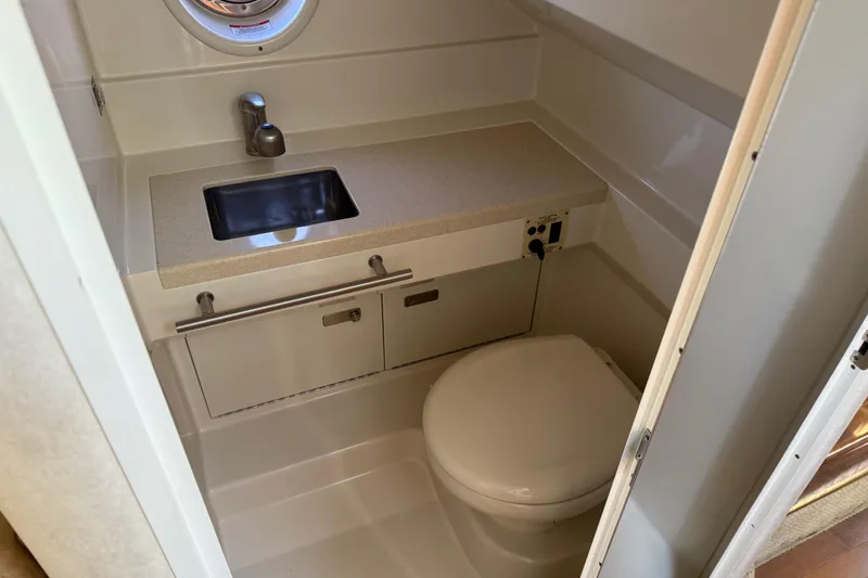 Slide: The Image of Compact bathroom in 2010 Sea Ray 310 Sundancer boat with sink and toilet. - 15