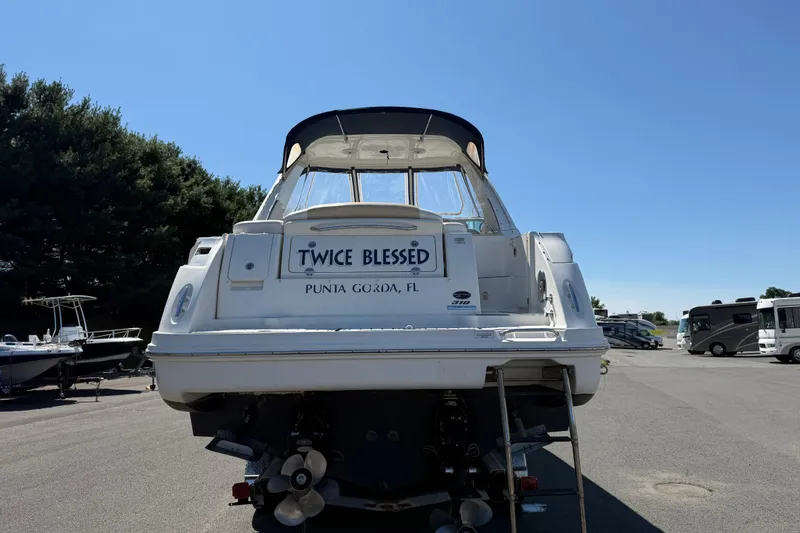 Slide: The Image of 2010 Sea Ray 310 Sundancer boat named "Twice Blessed" in a parking lot. - 3