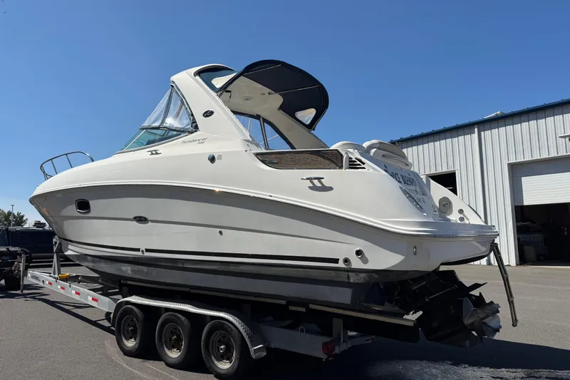 Slide: The Image of 2010 Sea Ray 310 Sundancer boat on trailer under clear blue sky. - 4