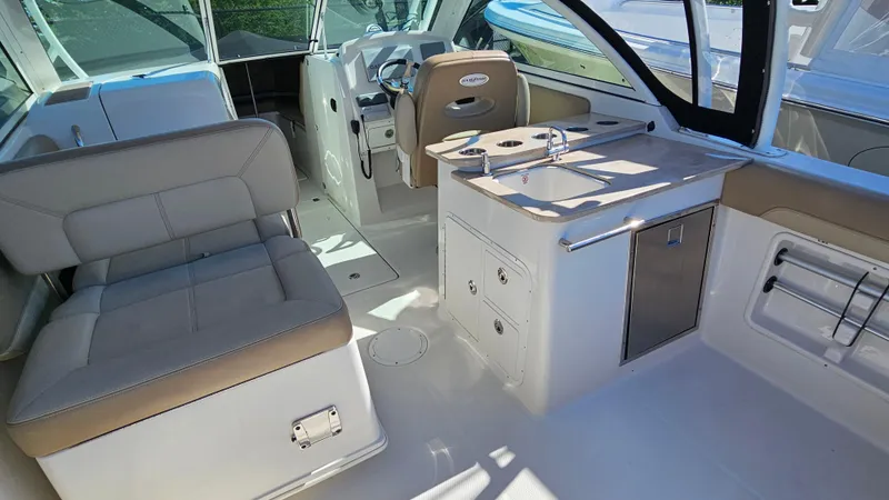 Slide: The Image of Interior of 2019 Sailfish 275 DC boat with seating and kitchenette area. - 11