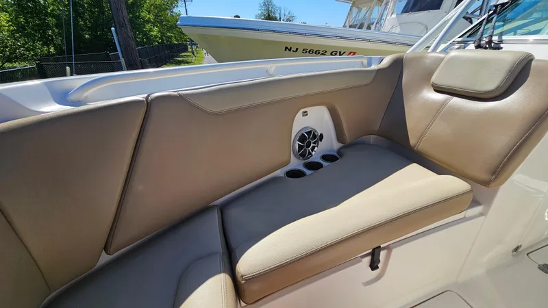 Slide: The Image of 2019 Sailfish 275 DC boat interior with beige seating and speaker system. - 32