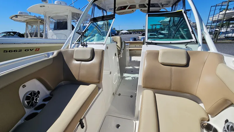 Slide: The Image of 2019 Sailfish 275 DC boat interior with beige seating and open cockpit. - 34