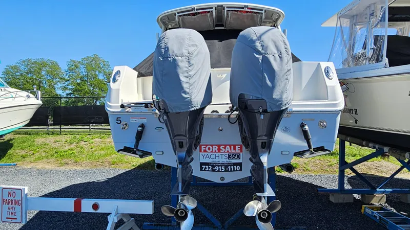 Slide: The Image of 2019 Sailfish 275 DC boat for sale with dual outboard motors, parked on a trailer. - 43