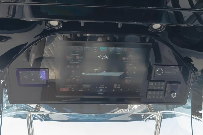 Slide: The Image of 2026 Mag Bay 43 CC boat dashboard with advanced touchscreen controls and navigation system. - 10