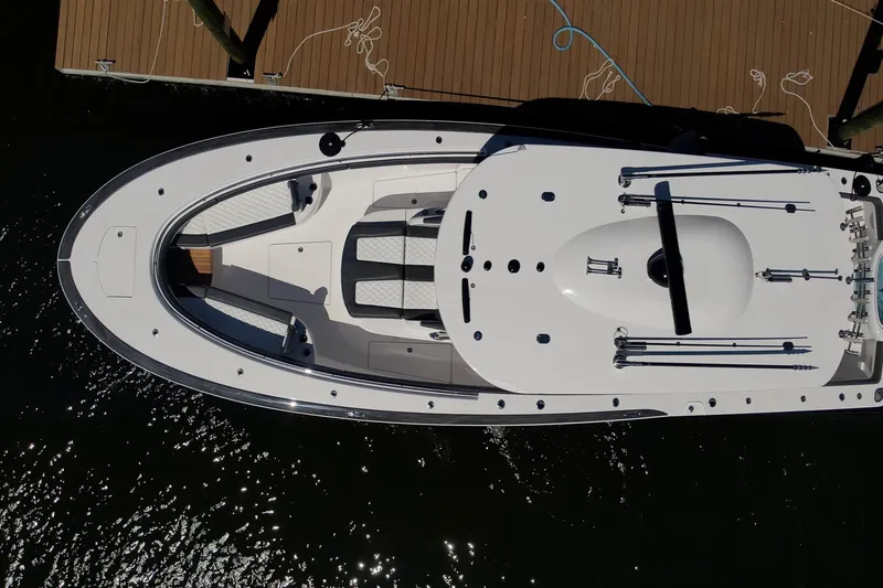 Slide: The Image of Overhead view of 2026 Mag Bay 43 CC boat docked, showcasing sleek design and spacious deck. - 18