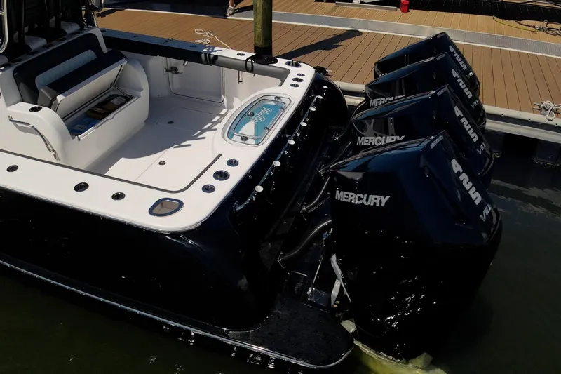 Slide: The Image of 2026 Mag Bay 43 CC boat with Mercury outboard engines docked at marina. - 19