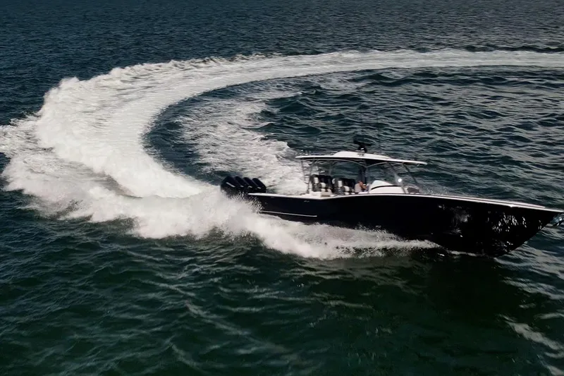 Slide: The Image of 2026 Mag Bay 43 CC boat making a sharp turn on open water. - 23