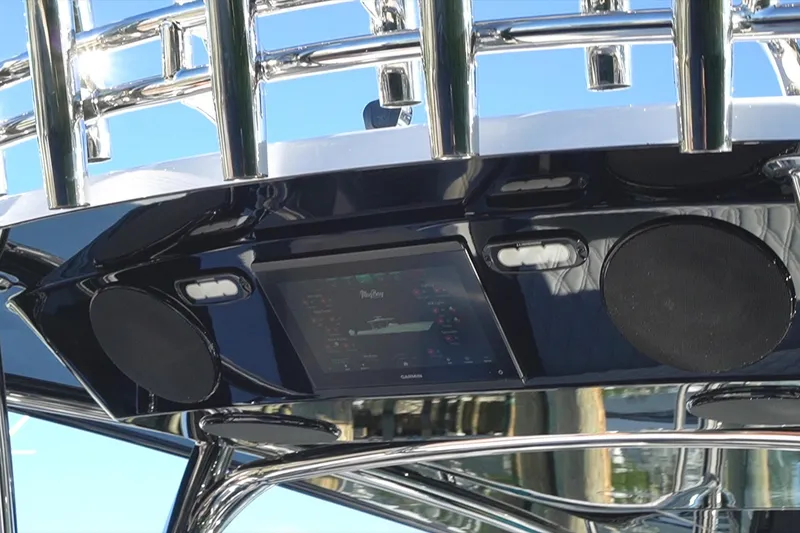 Slide: The Image of 2026 Mag Bay 43 CC boat dashboard with speakers and navigation screen. - 24