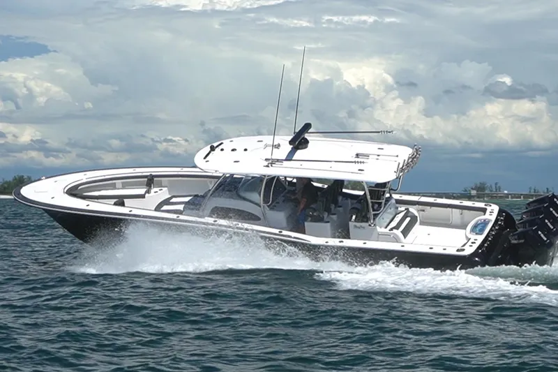 Slide: The Image of 2026 Mag Bay 43 CC cruising on open water under cloudy skies. - 27