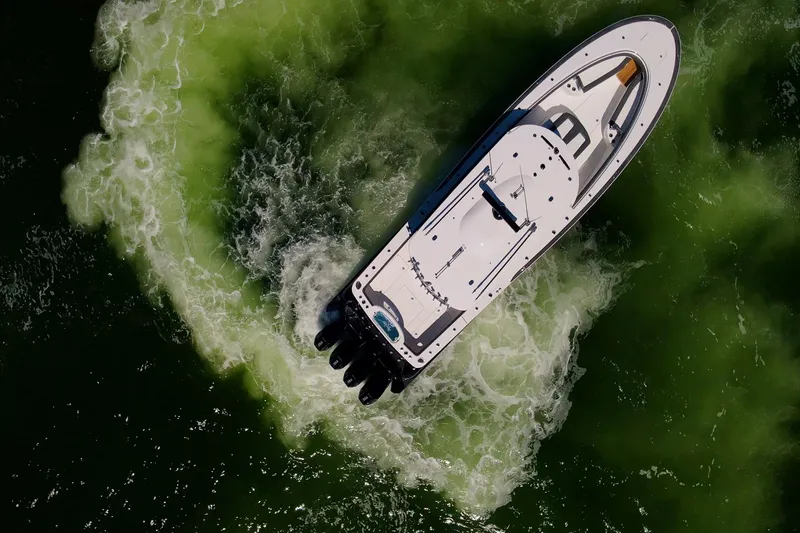 Slide: The Image of Aerial view of 2026 Mag Bay 43 CC boat navigating green waters. - 28
