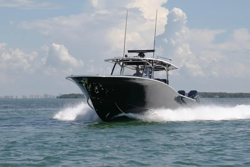 Slide: The Image of 2026 Mag Bay 43 CC boat cruising on open water under a clear sky. - 3