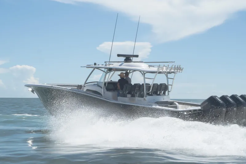 Slide: The Image of 2026 Mag Bay 43 CC boat cruising on open water under clear skies. - 5