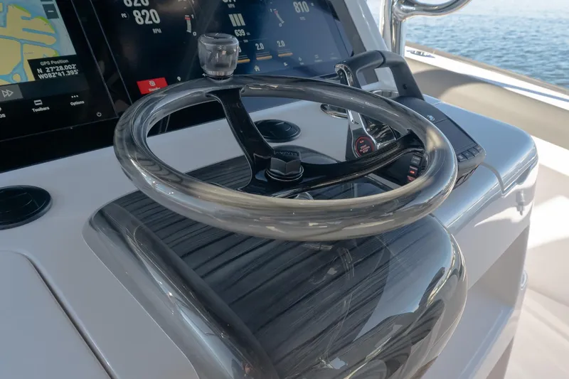 Slide: The Image of Steering wheel and controls of 2026 Mag Bay 43 CC boat, featuring advanced navigation displays. - 9