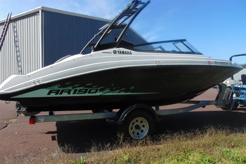 Slide: The Image of 2023 Yamaha Boats AR190 on trailer, parked outdoors near a metal building. - 5
