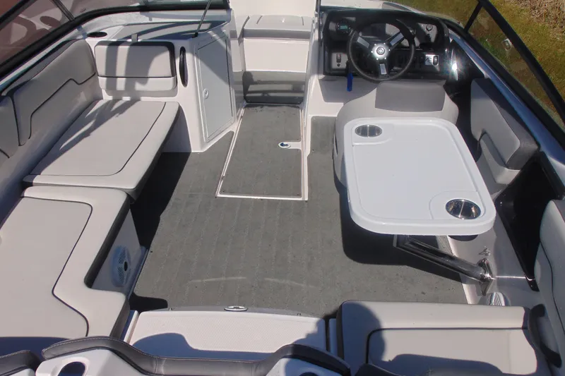 Slide: The Image of 2023 Yamaha Boats AR190 interior with seating and table, showcasing modern design and functionality. - 7