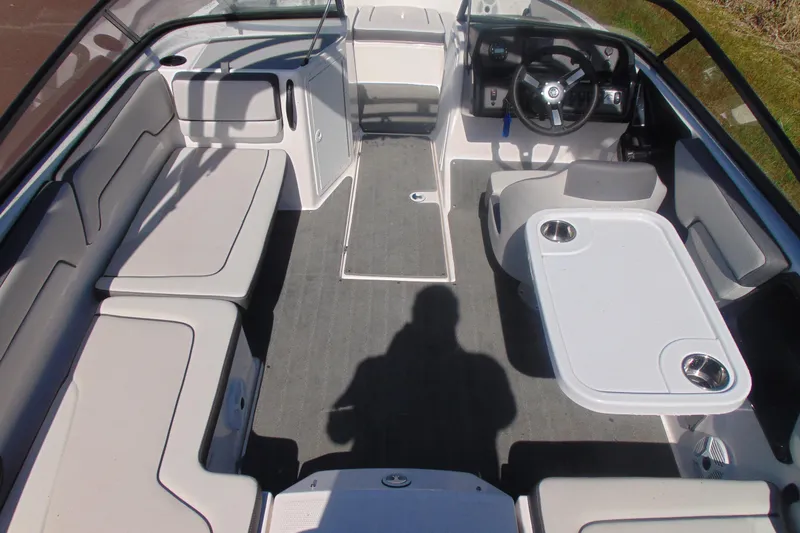 Slide: The Image of 2023 Yamaha Boats AR190 interior with seating, steering wheel, and table setup. - 8