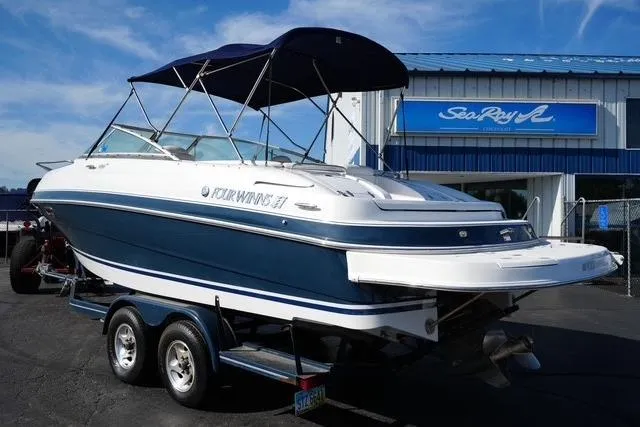 Slide: The Image of 2004 Four Winns 245 Sundowner boat on trailer, parked outside dealership. - 6