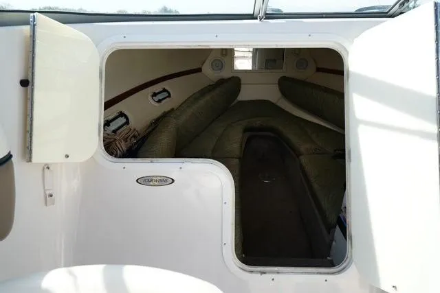 Slide: The Image of 2004 Four Winns 245 Sundowner cabin interior with seating and storage. - 9