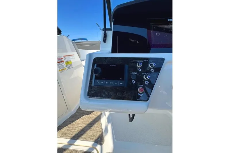 Slide: The Image of Control panel of 2021 Sea Ray SPX 210 Outboard boat with navigation and audio controls. - 12