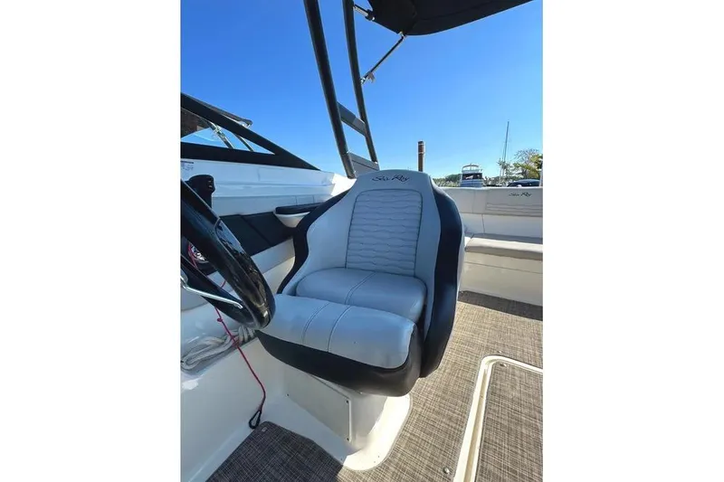 Slide: The Image of 2021 Sea Ray SPX 210 Outboard boat interior with steering wheel and seating. - 13
