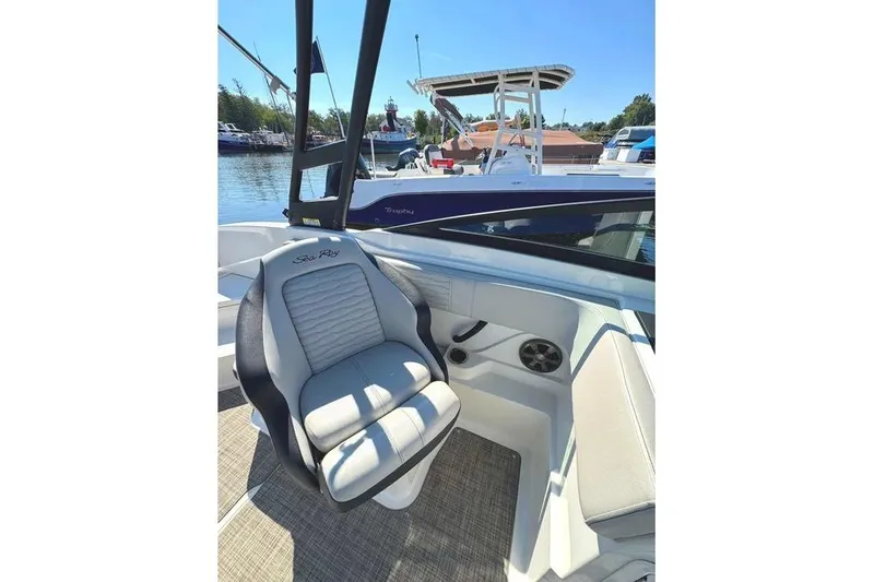 Slide: The Image of 2021 Sea Ray SPX 210 Outboard boat interior with comfortable seating and waterfront view. - 14