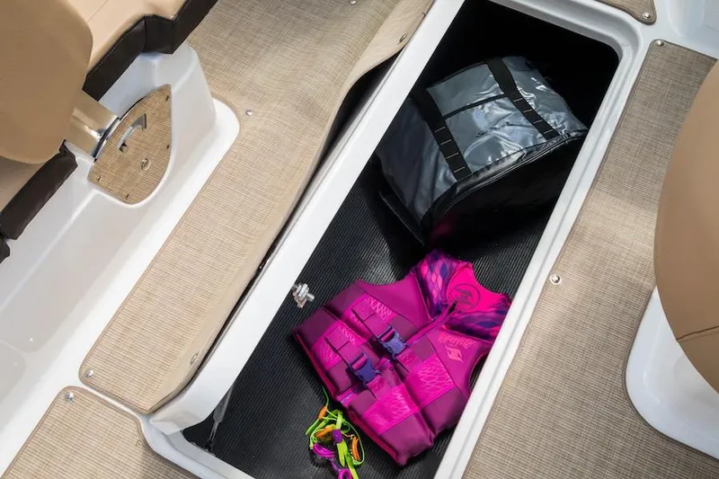 Slide: The Image of Manufacturer Provided Image: Storage compartment of 2021 Sea Ray SPX 210 OB with life jacket and bag. - 18