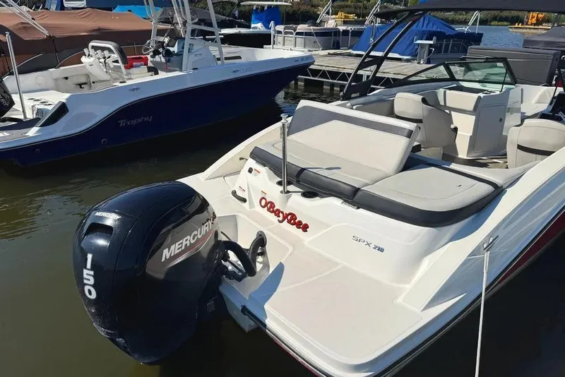 Slide: The Image of 2021 Sea Ray SPX 210 Outboard boat with Mercury 150 engine docked at marina. - 24
