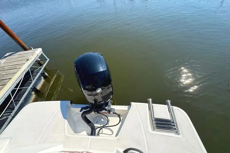 Slide: The Image of 2021 Sea Ray SPX 210 Outboard motorboat at dock, rear view with water reflection. - 28