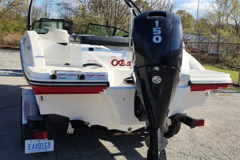 Slide: The Image of 2021 Sea Ray SPX 210 Outboard boat with 150 HP engine, parked on a trailer. - 31