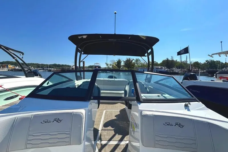 Slide: The Image of 2021 Sea Ray SPX 210 Outboard boat docked at marina under clear blue sky. - 6
