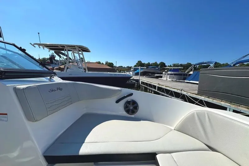 Slide: The Image of 2021 Sea Ray SPX 210 Outboard boat interior at marina, clear blue sky. - 7