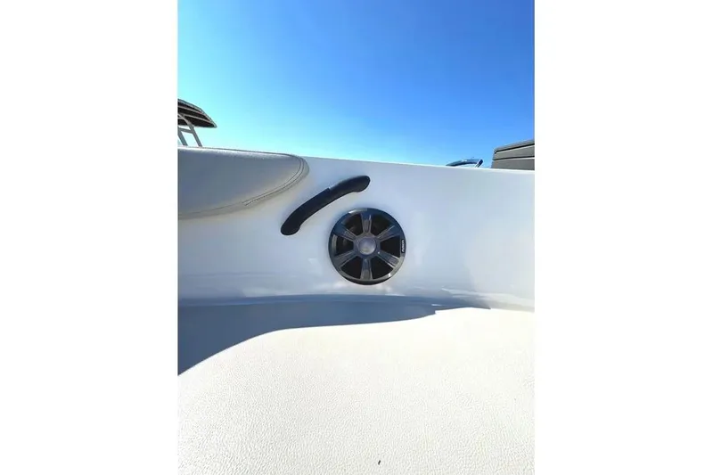 Slide: The Image of 2021 Sea Ray SPX 210 Outboard boat interior with speaker and handle, under clear blue sky. - 8