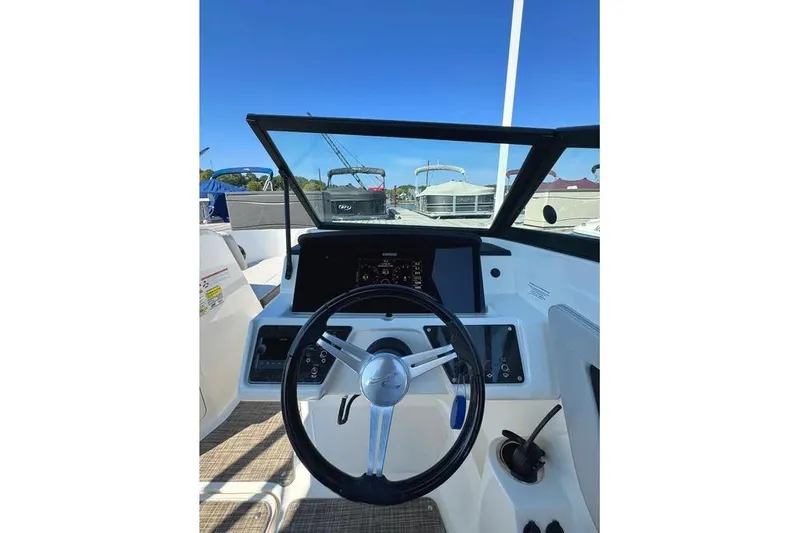 Slide: The Image of 2021 Sea Ray SPX 210 Outboard boat dashboard with steering wheel and controls. - 9