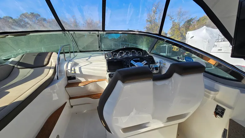 Slide: The Image of Interior view of 2014 Sea Ray 350 Sundancer boat cockpit with dual seats and dashboard. - 10