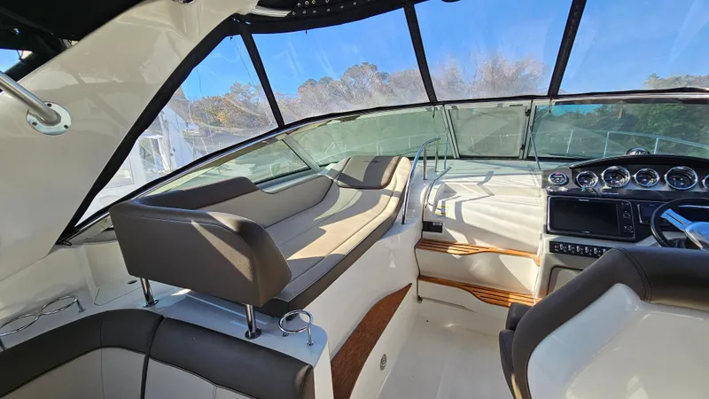 Slide: The Image of 2014 Sea Ray 350 Sundancer cockpit with modern seating and navigation controls. - 11